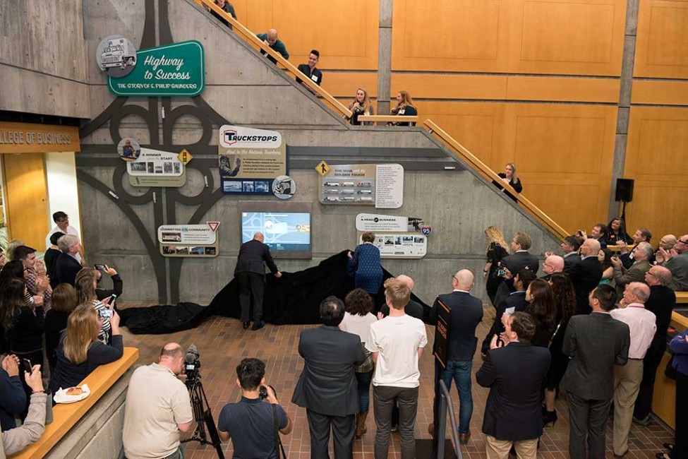 Unveiling a display in the College of Business