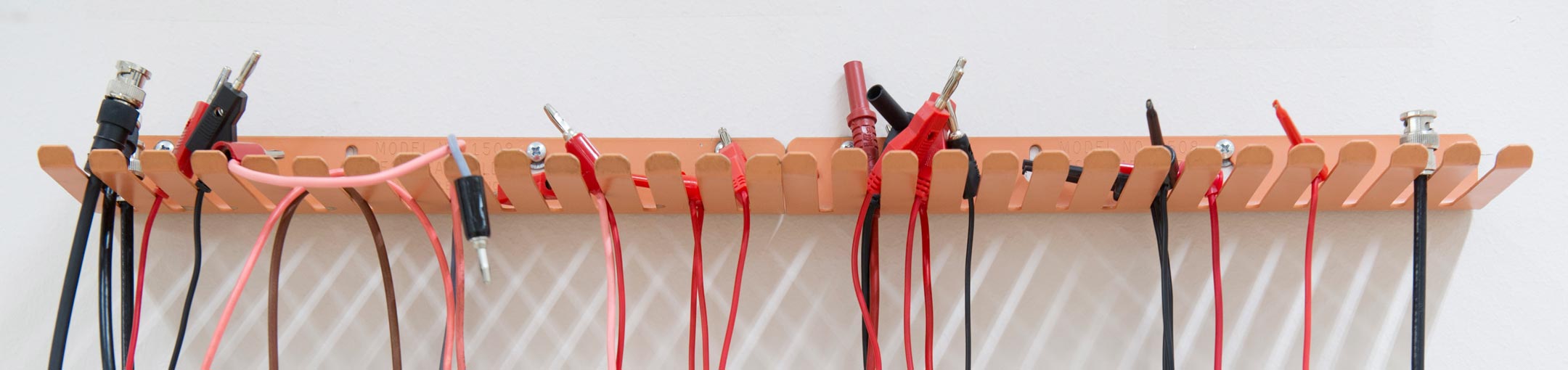 Wires hanging from hooks in the wall