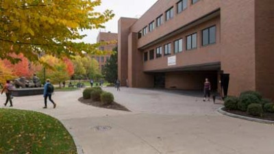 Students walking across campus on a fall day