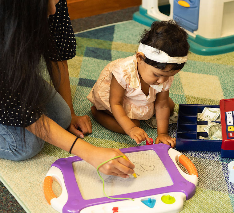 Mother and baby in PLAY Lab playing with toys.