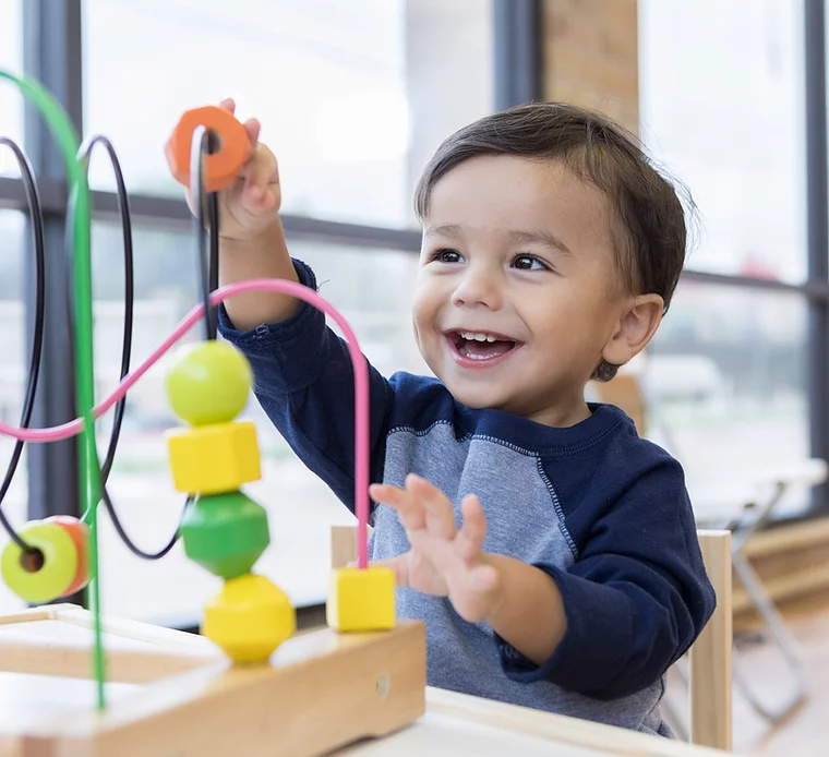 Baby playing and touching toys.