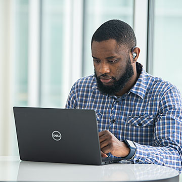 Photo of male student working on a laptop