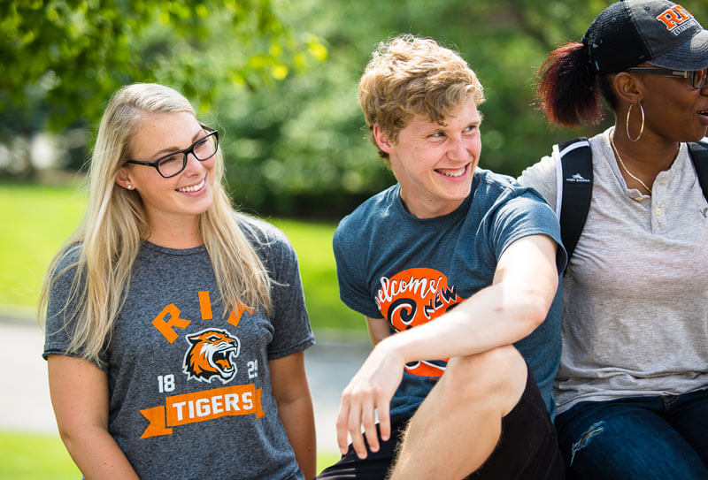 Three R I T students smiling